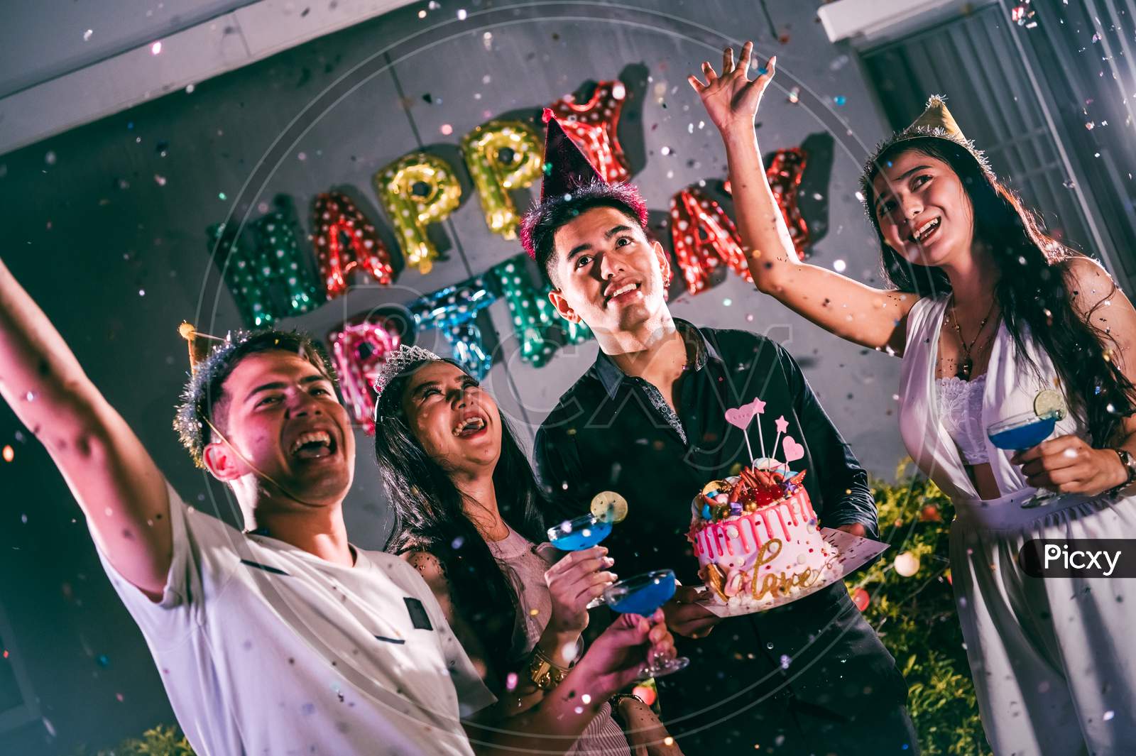 Asian Friends Having Fun In Birthday Party At Night Club With Birthday Cake. Event And Anniversary Concept. People Lifestyles And Friendship.