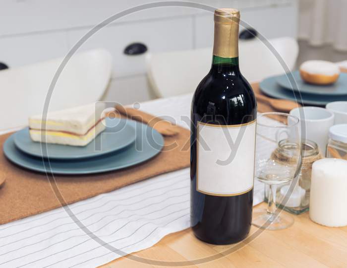 Drinking Wine Bottle On Dining Table. Beverage And Food Concept.