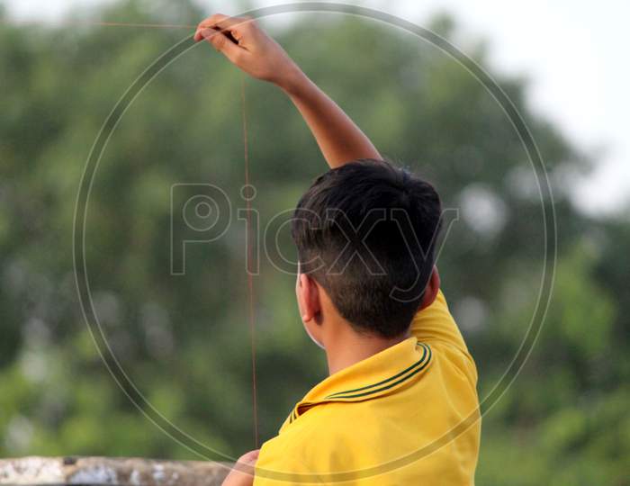 a children is trying to flying a kite but their kite is not flying