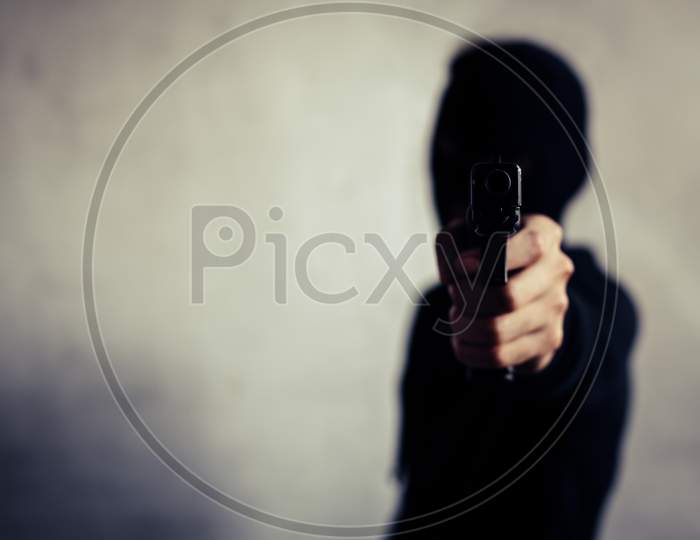 Man Aiming Gun And Ready To Shoot On Front View. People And Dangerous Weapons Concept. Criminal And Security Theme. Police And Robber Theme. Outlaw And Murderer Theme. Thief Gun Pointing As Shooter