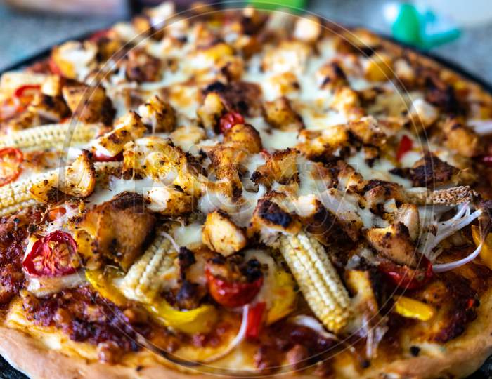 Top View Of Home Made Pizza With Sauce, Vegetables, Baby Corn, Corn, Tomatoes, Mushrooms And More