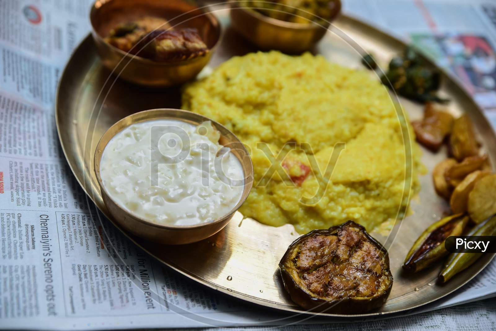 Traditional Indian dishes Paes and misti doi , blurred rice and non veg bengali meal. Special food preparation for rice ceremony in West Bengal