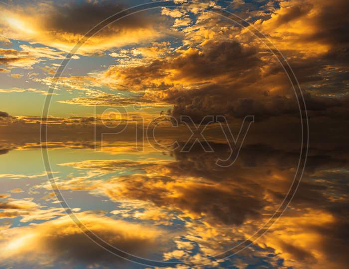Reflections Of Clouds During Sunset. Symmetrical Illustration, Resource For Designers.
