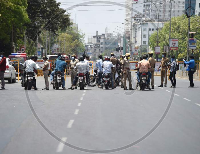 Commuters wait as a police personnel checks for valid travel credentials after a lockdown was reimposed as a preventive measure against the spread of the COVID-19 coronavirus, in Chennai on June 19, 2020. The epidemic has badly hit India's densely populated major cities and Chennai in the south has