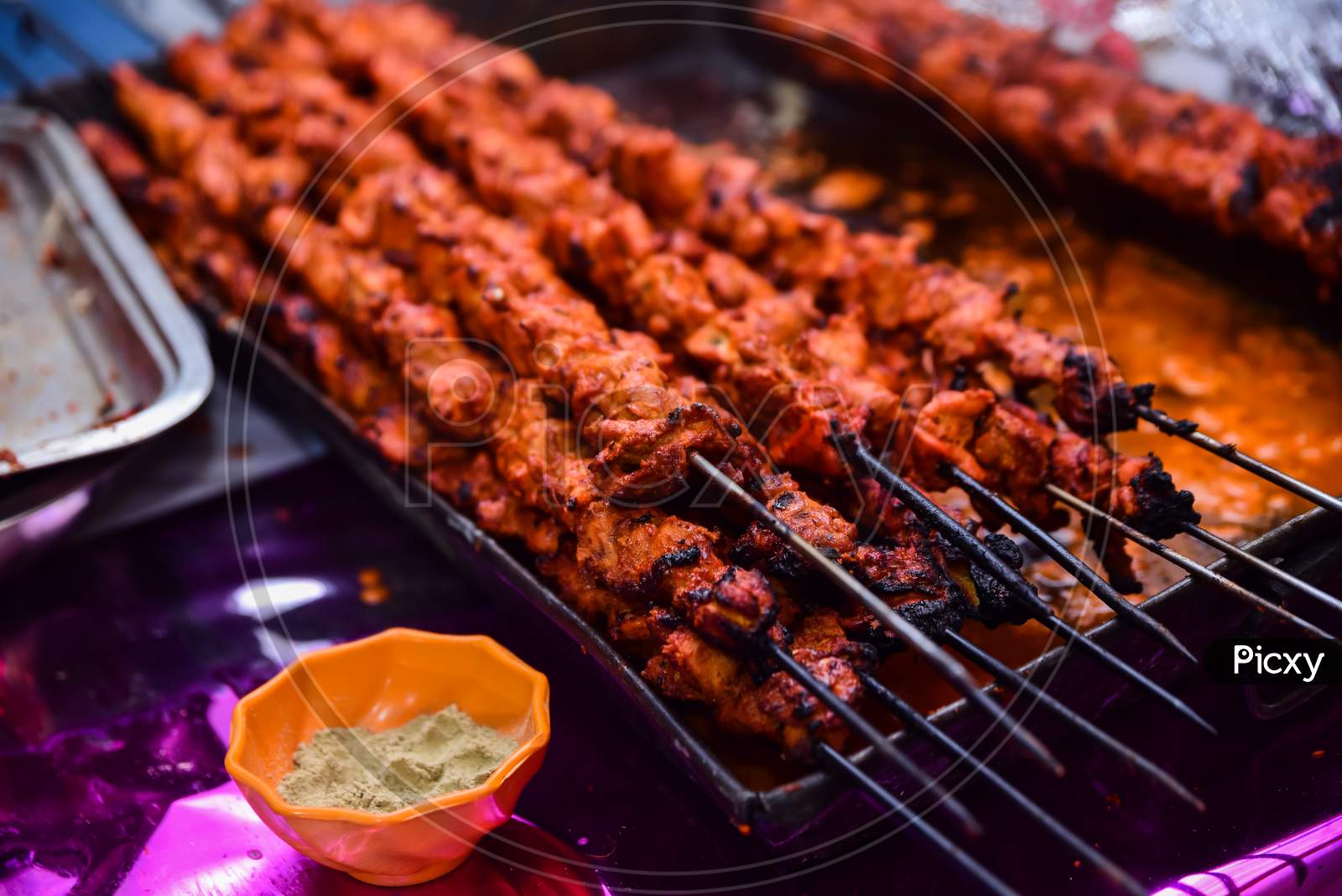 Barbecue Chicken Kebabs On The Hot Grill Close-up. Flames of Fire In The Background