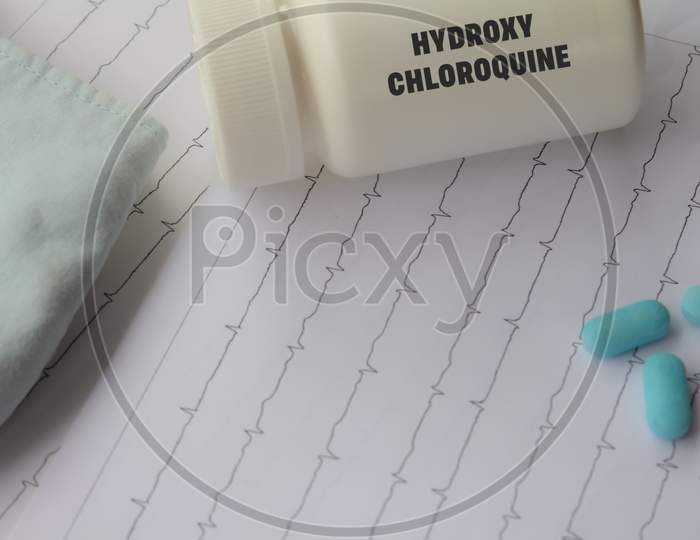 Doctor'S Desk. Medical Elements Related To Coronavirus. Medication Dispenser With The Word Hydroxychloroquine Written On It.