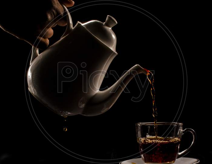 Pouring tea into the cup