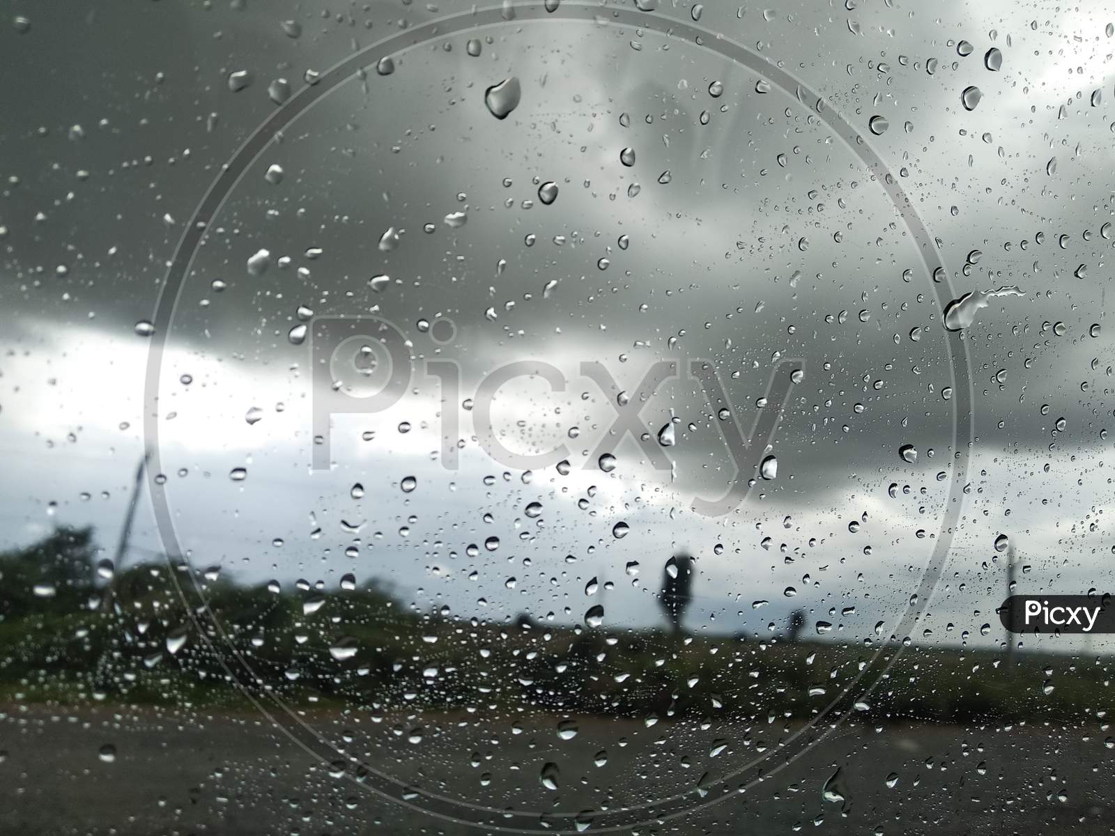 Car window Glass Rain drops nature view on the way