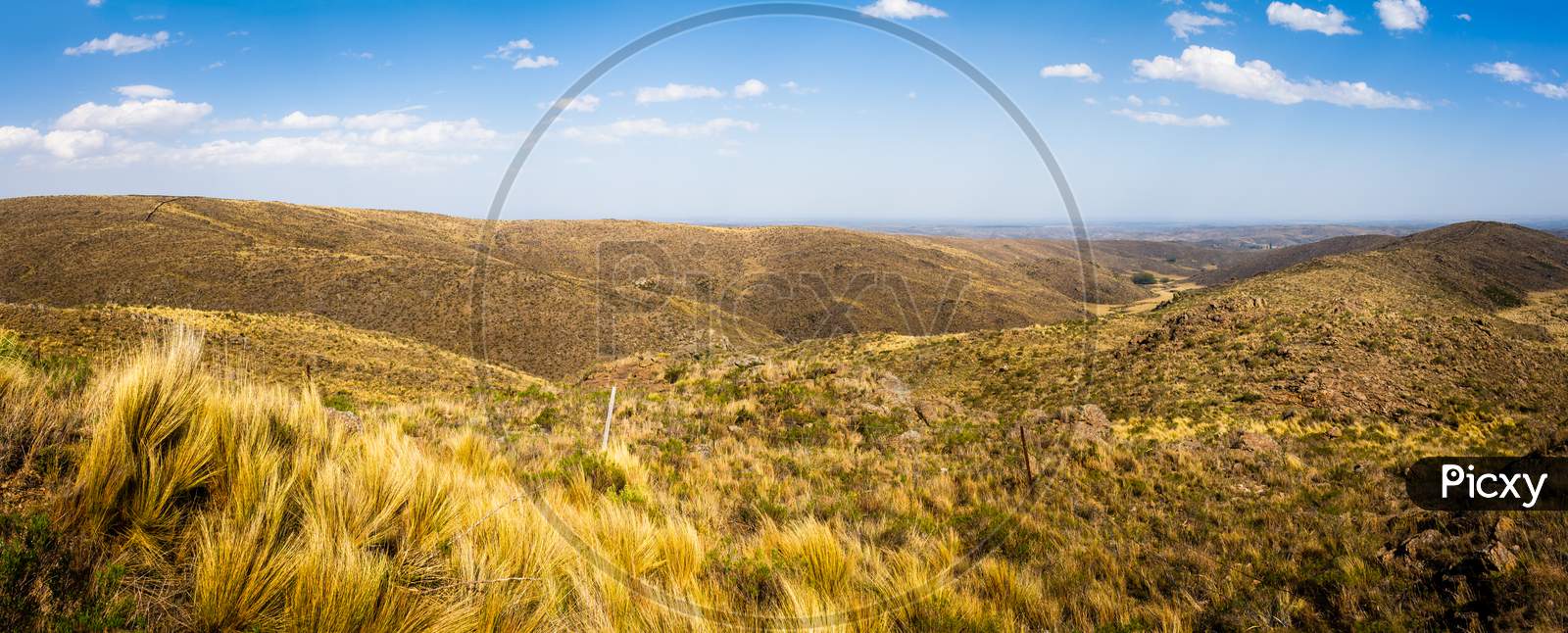 Beautiful Panoramic View Of The San Luis Mountains In Argentina. Highway Runs Between Arid Mountainous Soil.