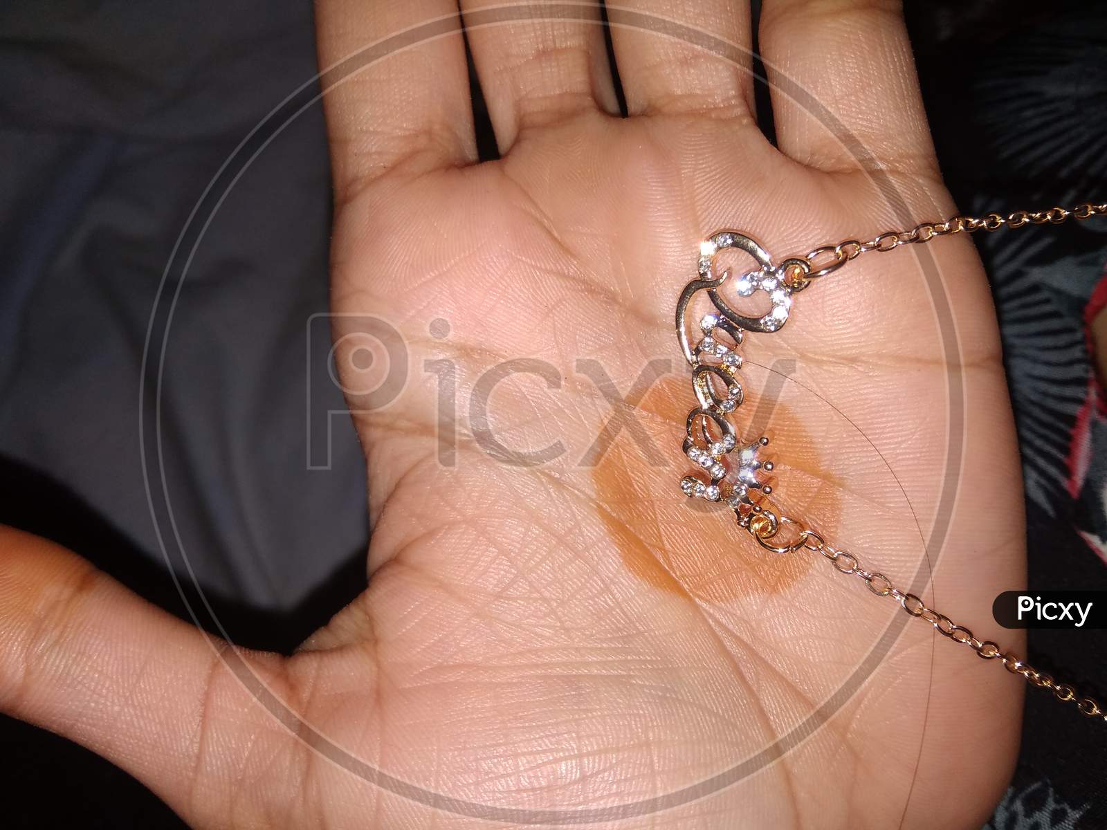 A girl hand with beautiful queen pendant.
