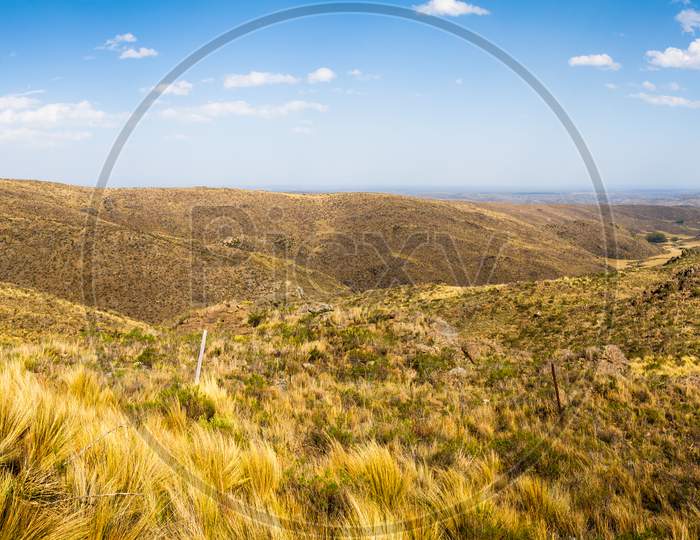 Beautiful Panoramic View Of The San Luis Mountains In Argentina. Highway Runs Between Arid Mountainous Soil.