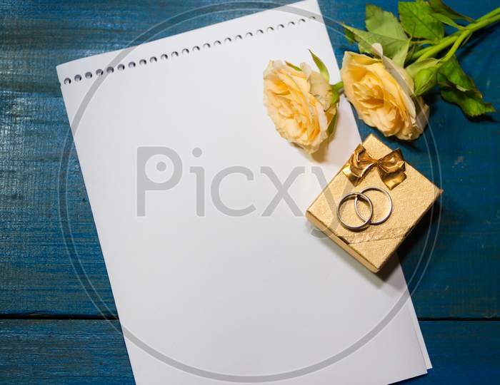 Box Of Rings On The Table With Roses And A Note