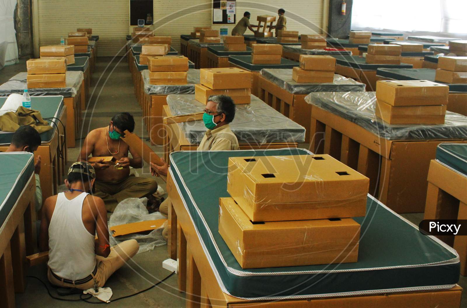 Bombay Municipal Corporation(BMC) workers prepare beds at the iconic St. Xavier's College which has been converted into a quarantine facility for COVID19 patients during an extended lockdown, to slow the spreading of coronavirus disease , in Mumbai, India on May 27, 2020.