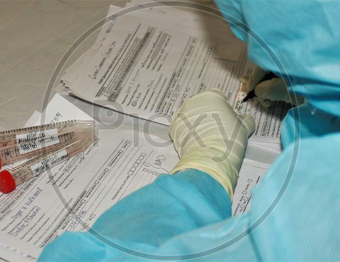 A medical staff writes down the details of a journalist after collecting his swab specimen, after the extension of the 21- day nationwide lockdown to limit the spreading of coronavirus disease (COVID-19) in Mumbai, India, on April 16, 2020.