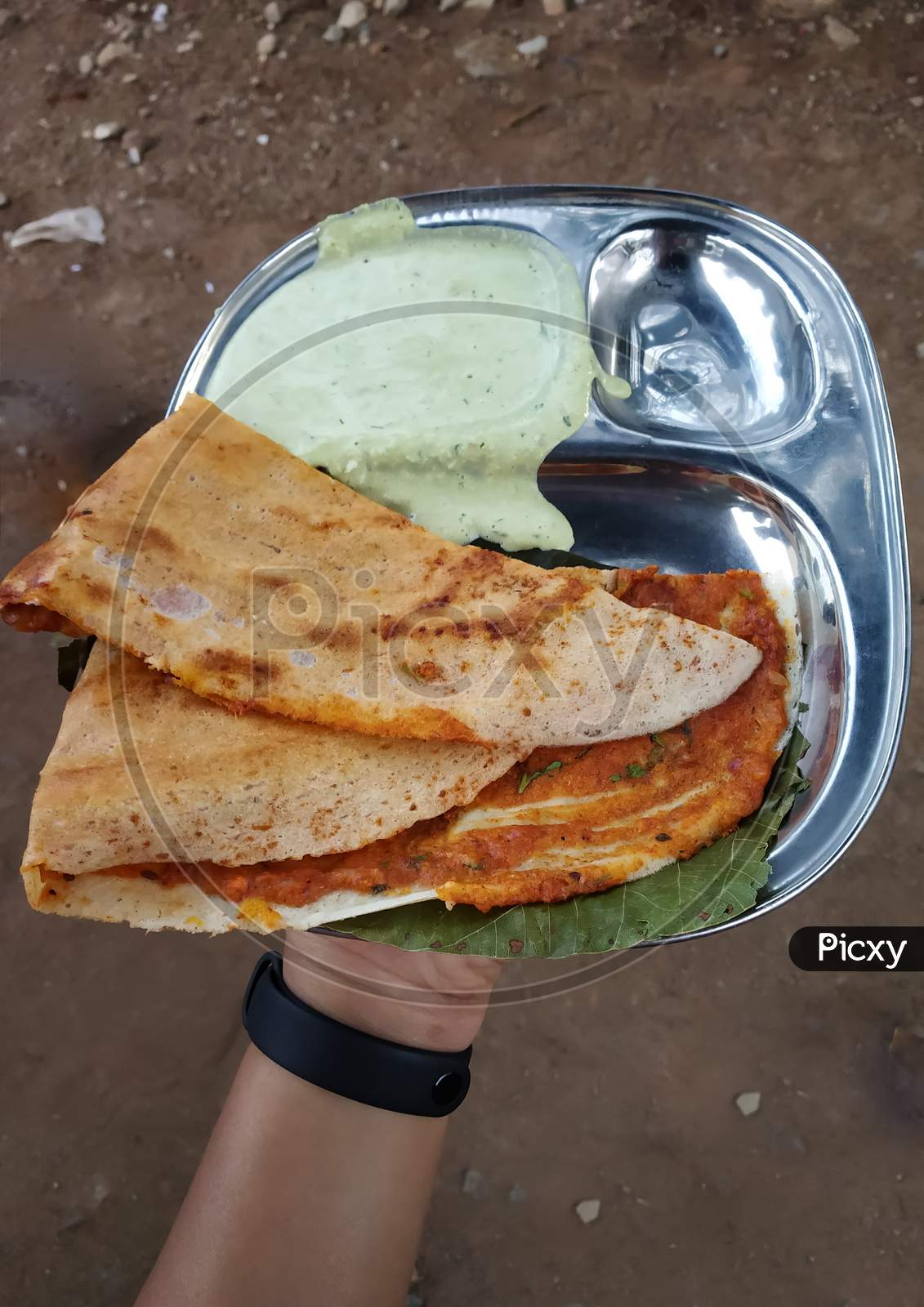 A hand holding Street Dosa