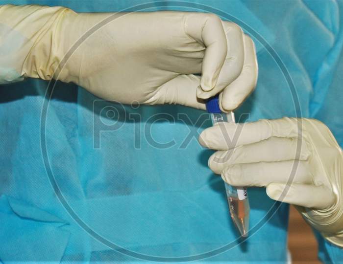 A medical staff holds a swab specimen collected from a jounalist, after the extension of the 21- day nationwide lockdown to limit the spreading of coronavirus disease (COVID-19) in Mumbai, India, on April 16, 2020.