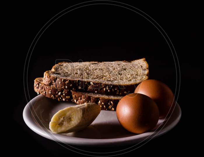 Varied Food To Prepare A Healthy Breakfast. Neutral Black Background With Pictorial Lighting. Healthy Diet Without Fats.
