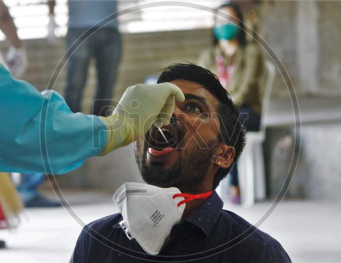A medical staff conducts a swab test of a journalist after the extension of the 21- day nationwide lockdown to limit the spreading of coronavirus disease (COVID-19) in Mumbai, India, on April 16, 2020.