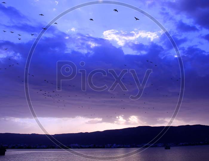 Birds Fly As Rain Clouds Are Seen In The Sky Over The Anasagar Lake In Ajmer, Rajasthan, India On 1 June 2020.