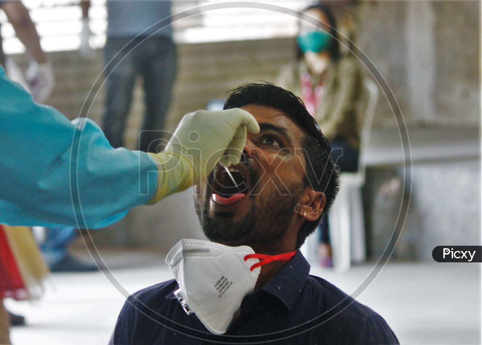 A medical staff conducts a swab test of a journalist after the extension of the 21- day nationwide lockdown to limit the spreading of coronavirus disease (COVID-19) in Mumbai, India, on April 16, 2020.