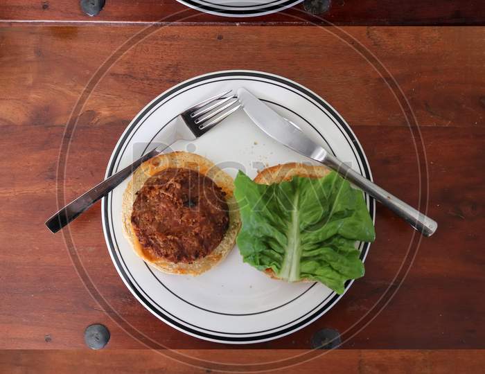 Timeline composing of homemade cooking of a grilled burger with tomatoes and salad on a plate