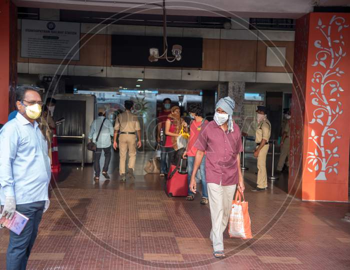 people getting out of railway station with masks