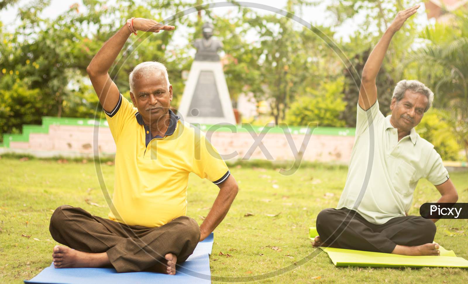 Happy Senior People Doing Yoga By Stretching Hands - Concept Of Senior People Fitness And Healthy Lifestyle - Two Elderly Man Busy In Morning Exercise