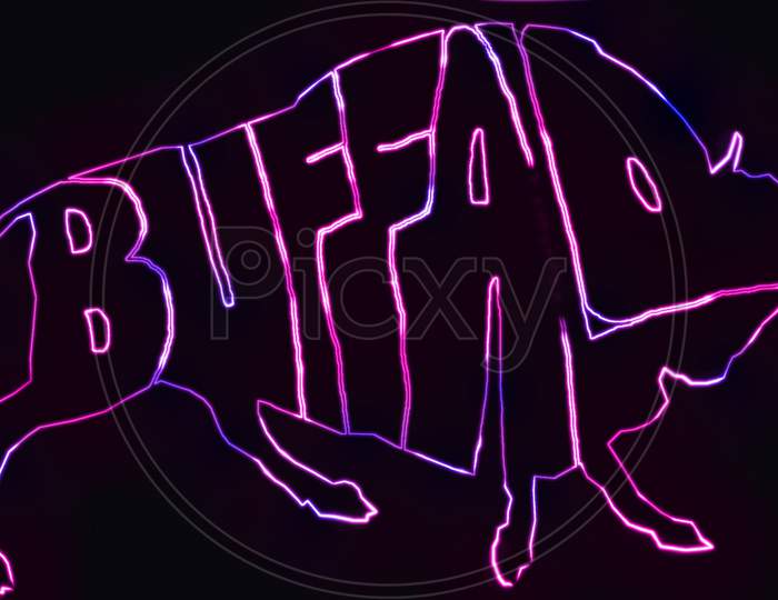 The text BUFFALO written in the shape of buffalo with neon light effect. animal text outline with neon light effect.