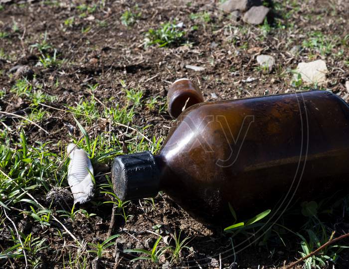 Closeup Shot Of Glass Bottle On The Ground