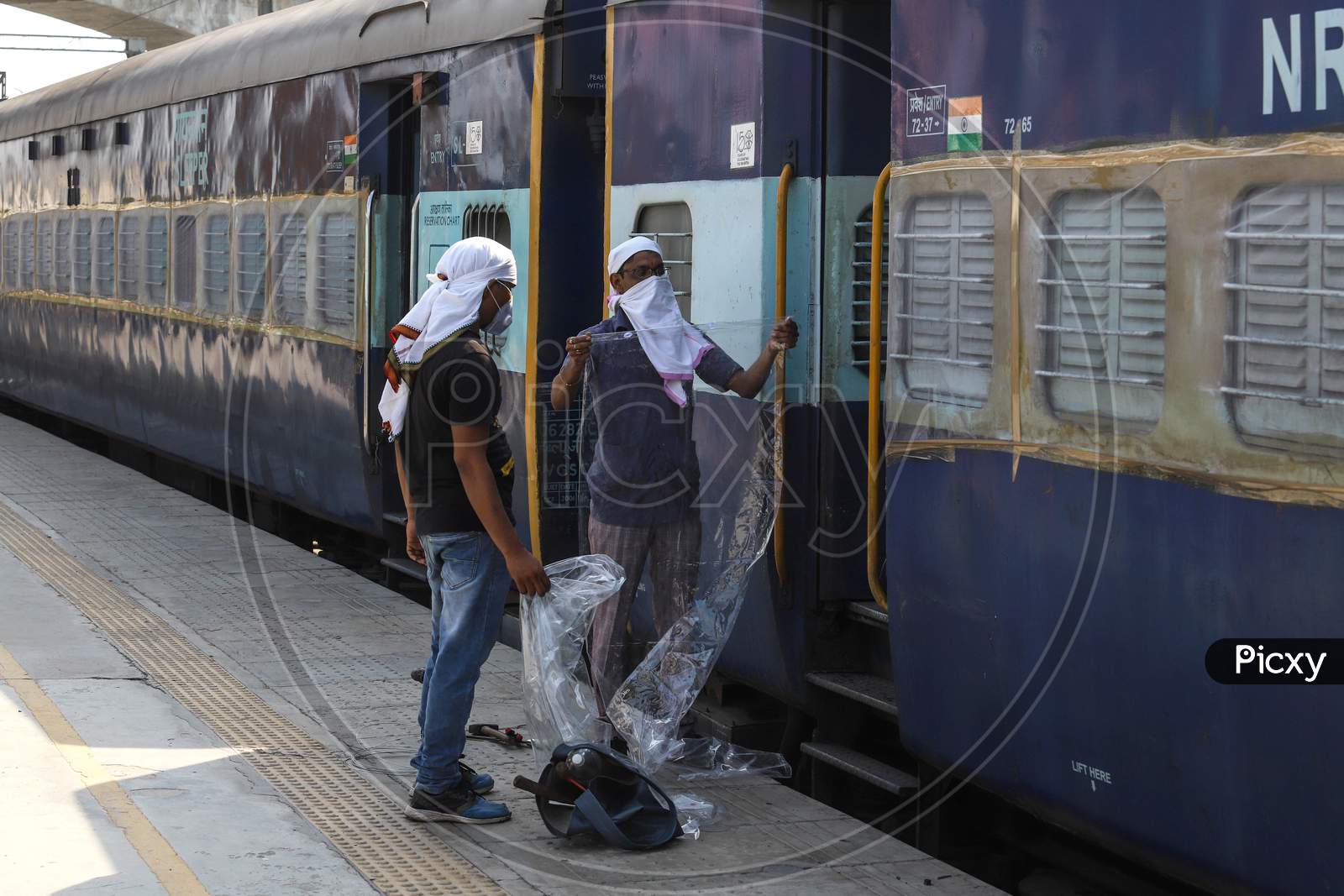 A Worker Fixes A Plastic Partition In A Train Coach That Has Been Converted Into An Isolation Ward For Coronavirus Patients At Anand Vihar Railway Station On June 17, 2020 In New Delhi, India.