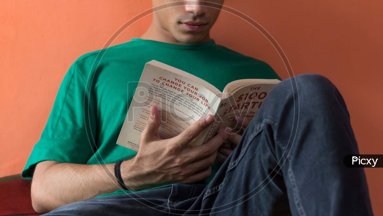 A Young Man Reading A Book.