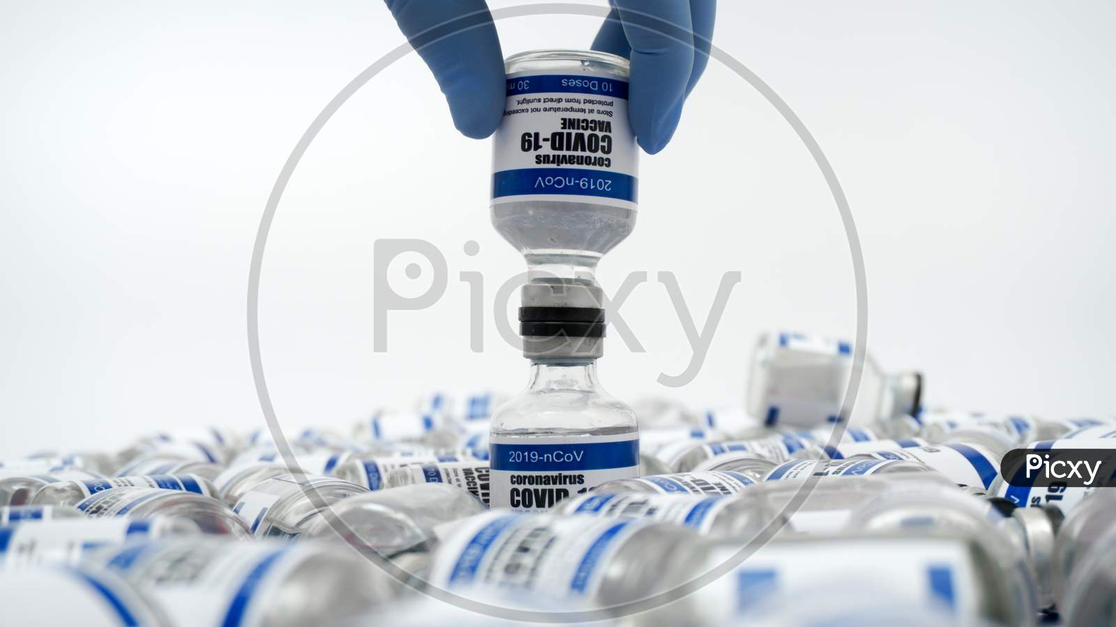 Covid-19 Corona Virus 2019-Ncov Vaccine Vials Medicine Drug Bottles Syringe Injection Blue Nitrile Surgical Gloves. Vaccination, Immunization, Treatment To Cure Covid 19 Corona Virus Infection Concept