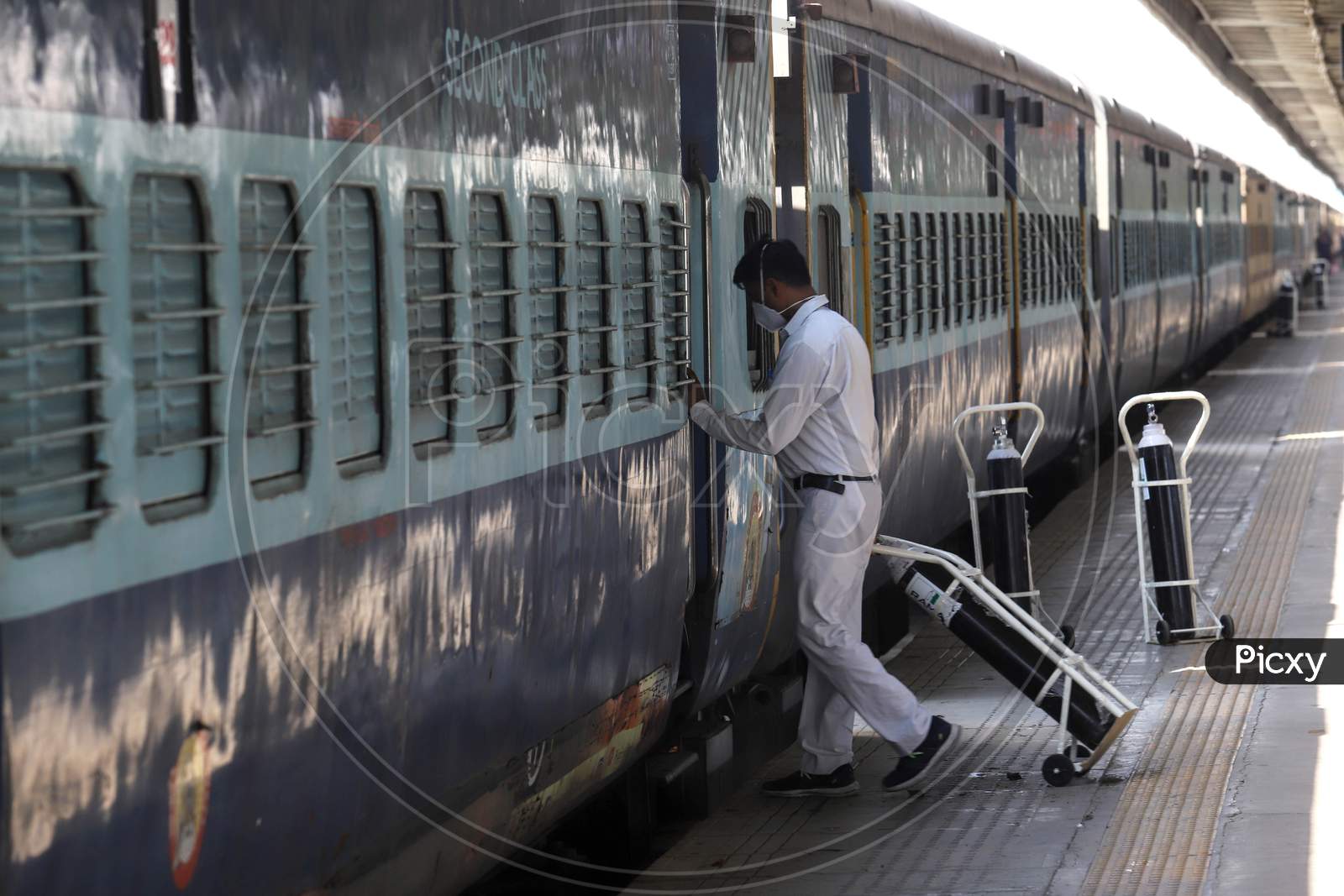 Worker Carry Oxygen Cylinders Inside Anand Vihar Railway Station, Where Train Coaches Being Temporarily Converted Into Covid-19 Isolation Facilities, In New Delhi, India On June 17, 2020.