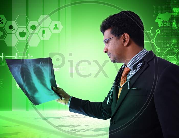 Male Doctor Looking At X-Ray