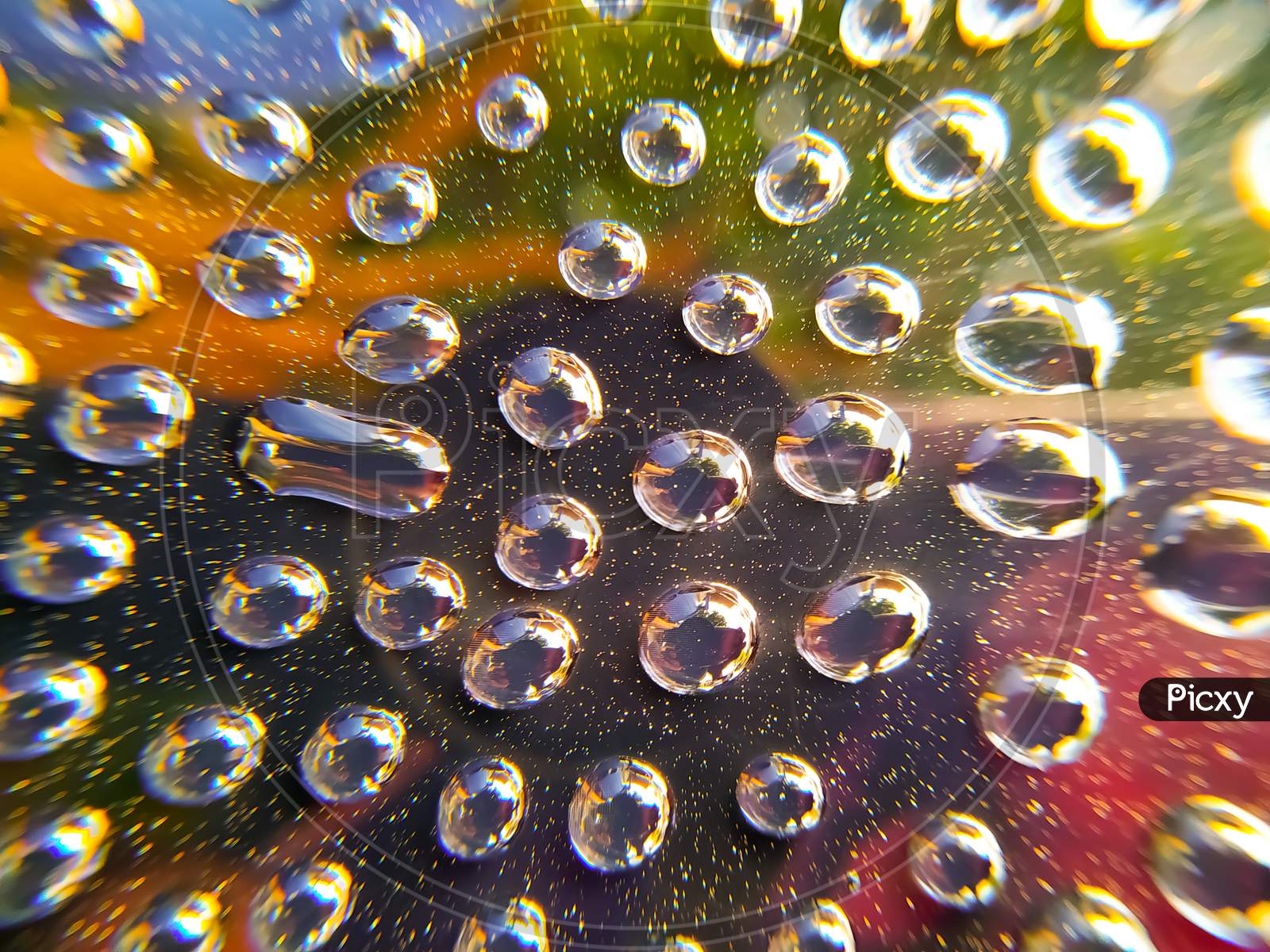 Water drops on a  colourful glass