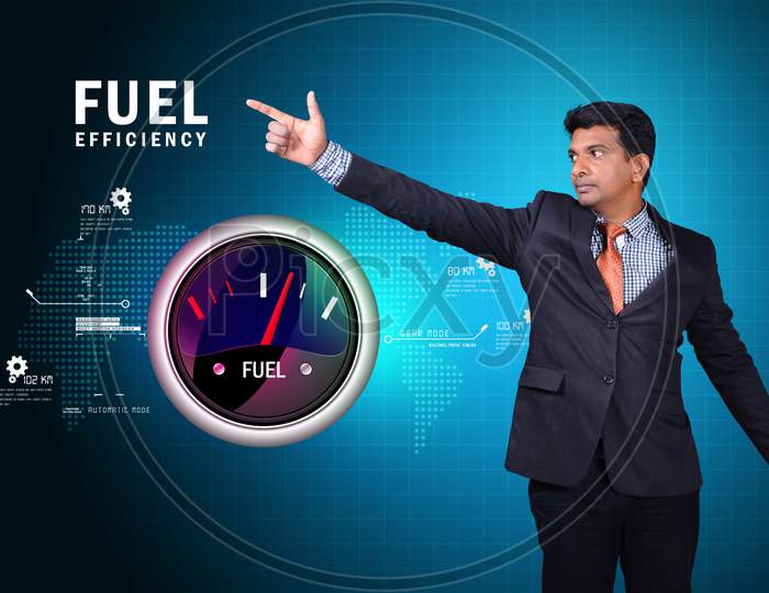 A Young Indian Man Pointing towards a Fuel Efficiency