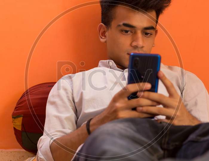 A Young Man Looking At His Cellphone