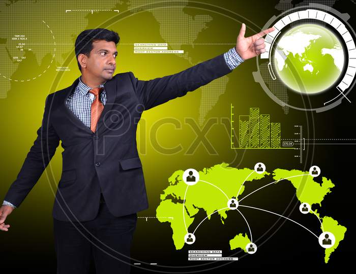 A Young Indian Man pointing towards a Globe