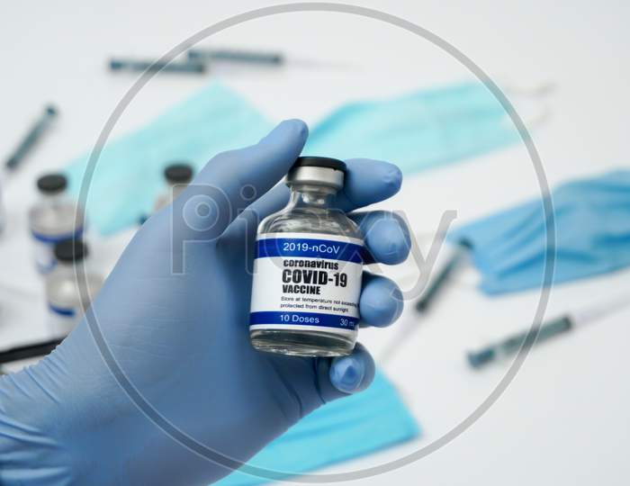 Covid-19 Corona Virus 2019-Ncov Vaccine Vials Medicine Drug Ampoule Bottle Closeup Syringe Injection Medical Nitrile Gloves Mask Glasses. Vaccination, Treatment To Cure Covid 19 Corona Virus Infection