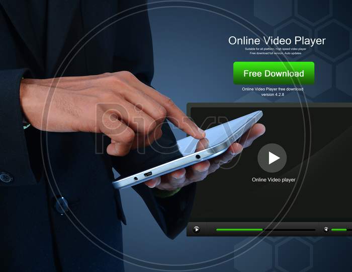 Close up shot of Person's Hand using a tablet or iPad with Online Video Player in the background