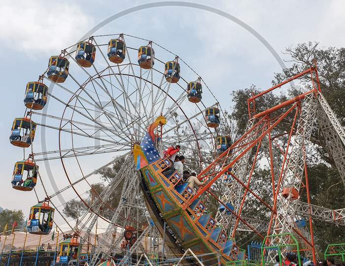 Mandi, Himachal Pradesh / India - February 28 2020: Photo of amazing colorful observation wheel in festival fair of India with selective focus, selective focus on subject, background blur