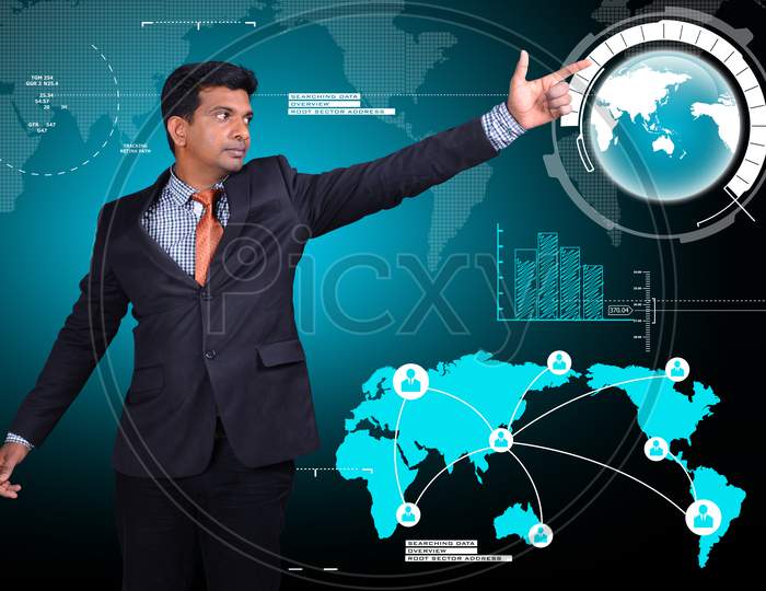 A Young Indian Man Pointing towards a World Globe