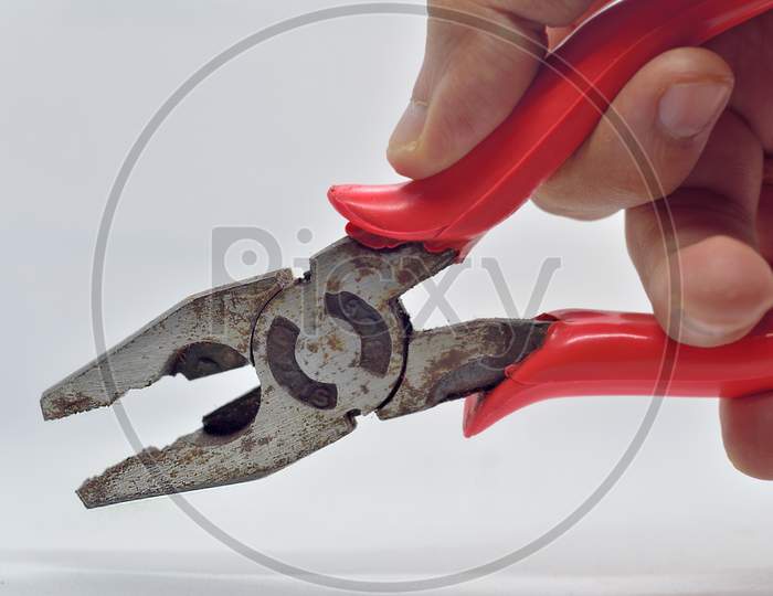 Old Used Iron Cutting Pliers Tongs Isolated In Hand On White Background