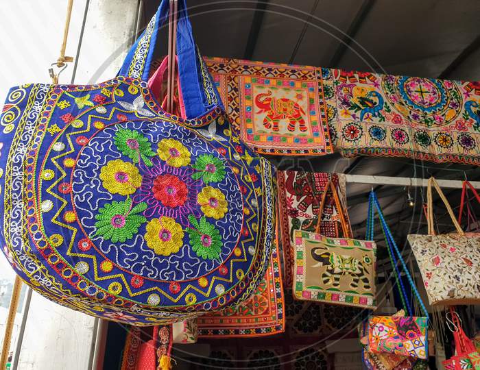 Mandi, Himachal Pradesh / India - February 28 2020: Photo of beautiful Rajasthani artwork hand bags hanging in shop  fair of India
