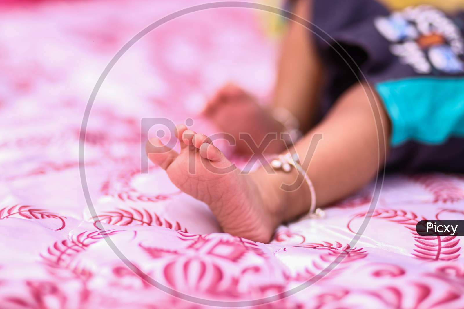 Legs of a newborn in closeup. Baby's feet and copy space. Infant care and colic