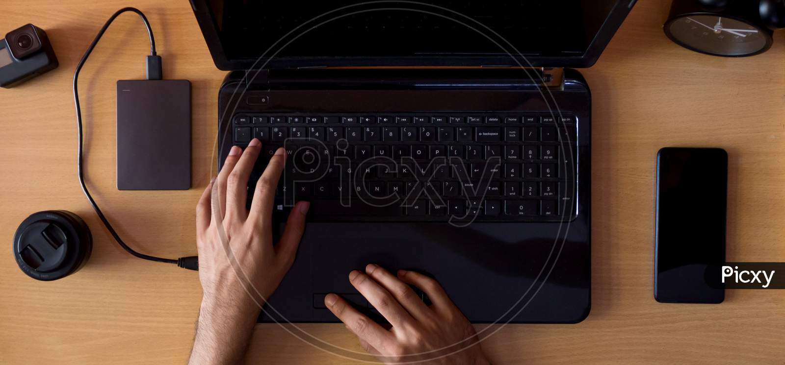 A Young man remotely working From Home On A Laptop