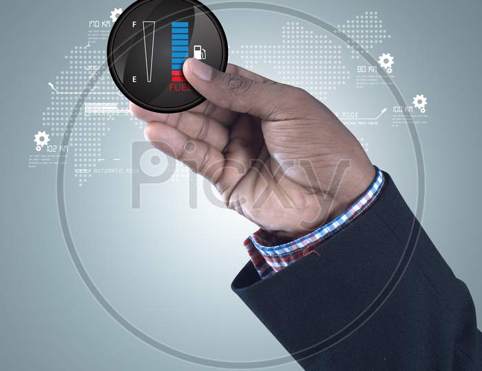 A Person holding A Fuel Indicator