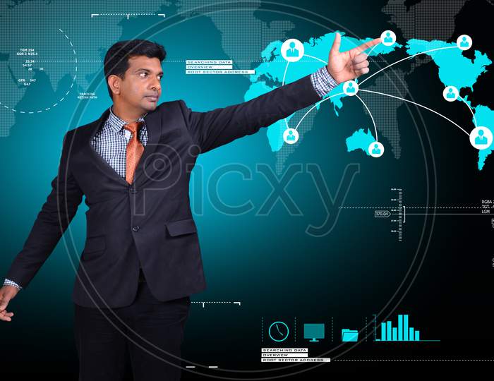Young Indian Man pointing towards a World Map
