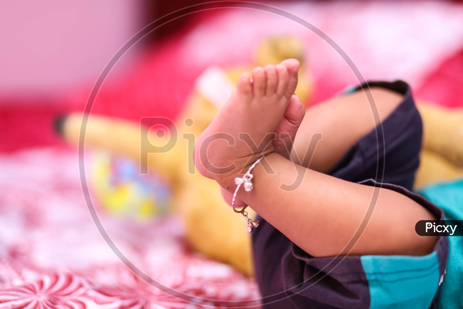Legs of a newborn in closeup. Baby's feet and copy space. Infant care and colic