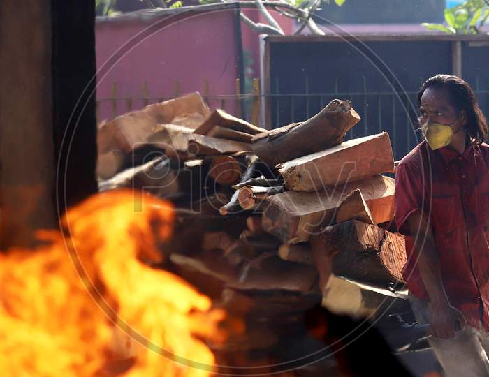 Navraj, A worker At Nigambodh Ghat Carries Cart Of Wooden logs to the crematorium ground For Last Rites Of People Who Died From Covid 19 In New Delhi, India On June 15, 2020.